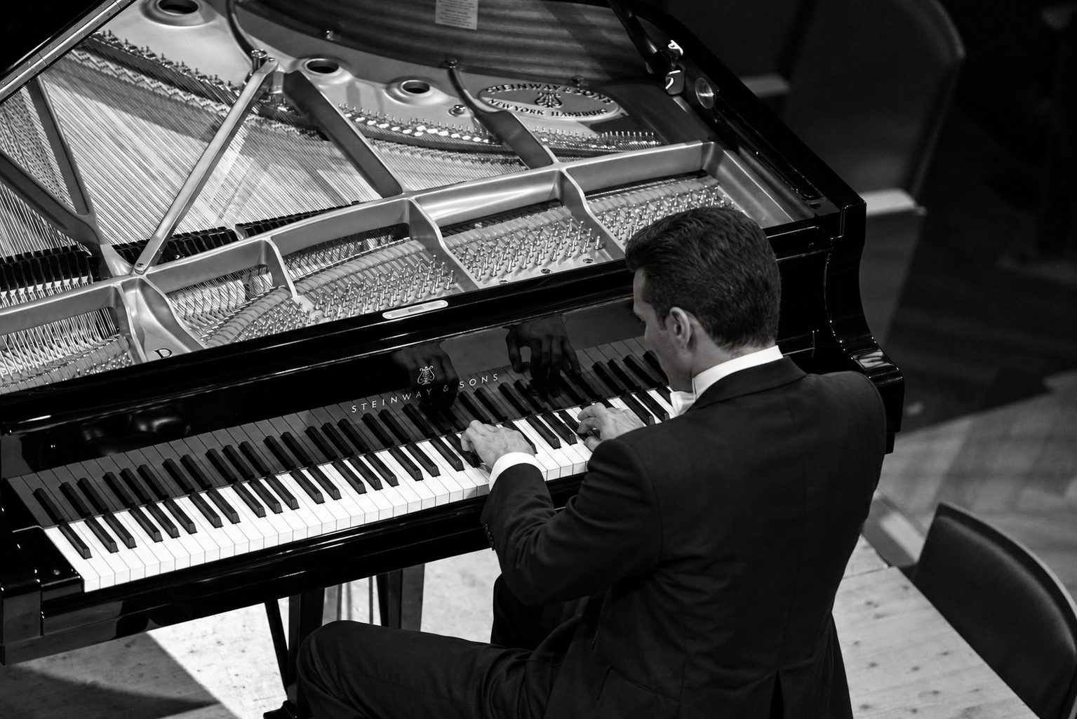 Overhead view of Simone Renzi&rsquo;s hands on the piano keyboard