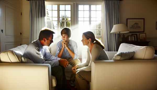 A photo of a family in a cozy living room, parents attentively talking and listening to their teenag